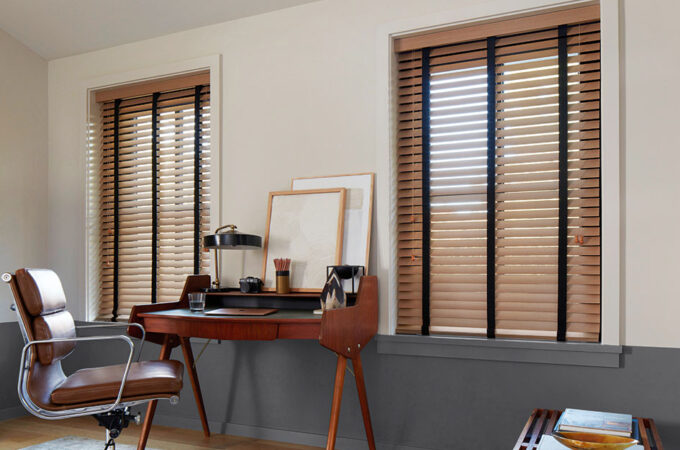 An office features inside mount wood blinds with black tape showing why you would choose inside vs outside mount blinds