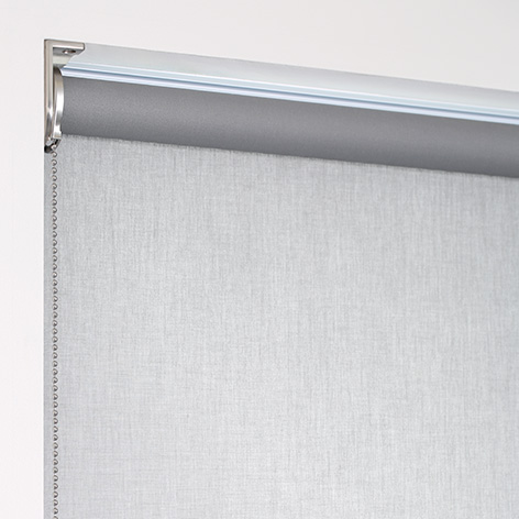 A product image of a roller shade with a regular roll, with material falling off the back of the tube