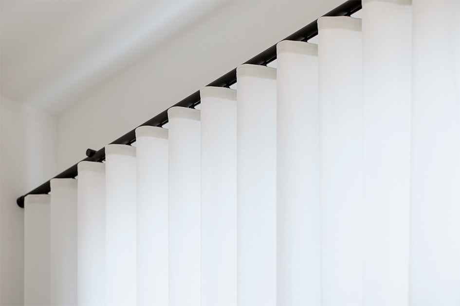 A close up of ripple fold drapery suggests how drapery is an alternative to shades for sliding glass doors