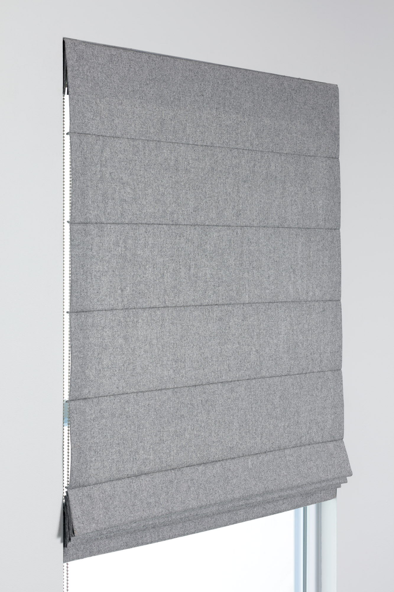 Cascade Roman Shade style in gray fabric with crisp horizontal pleats and back dowels for a structured, tailored look.