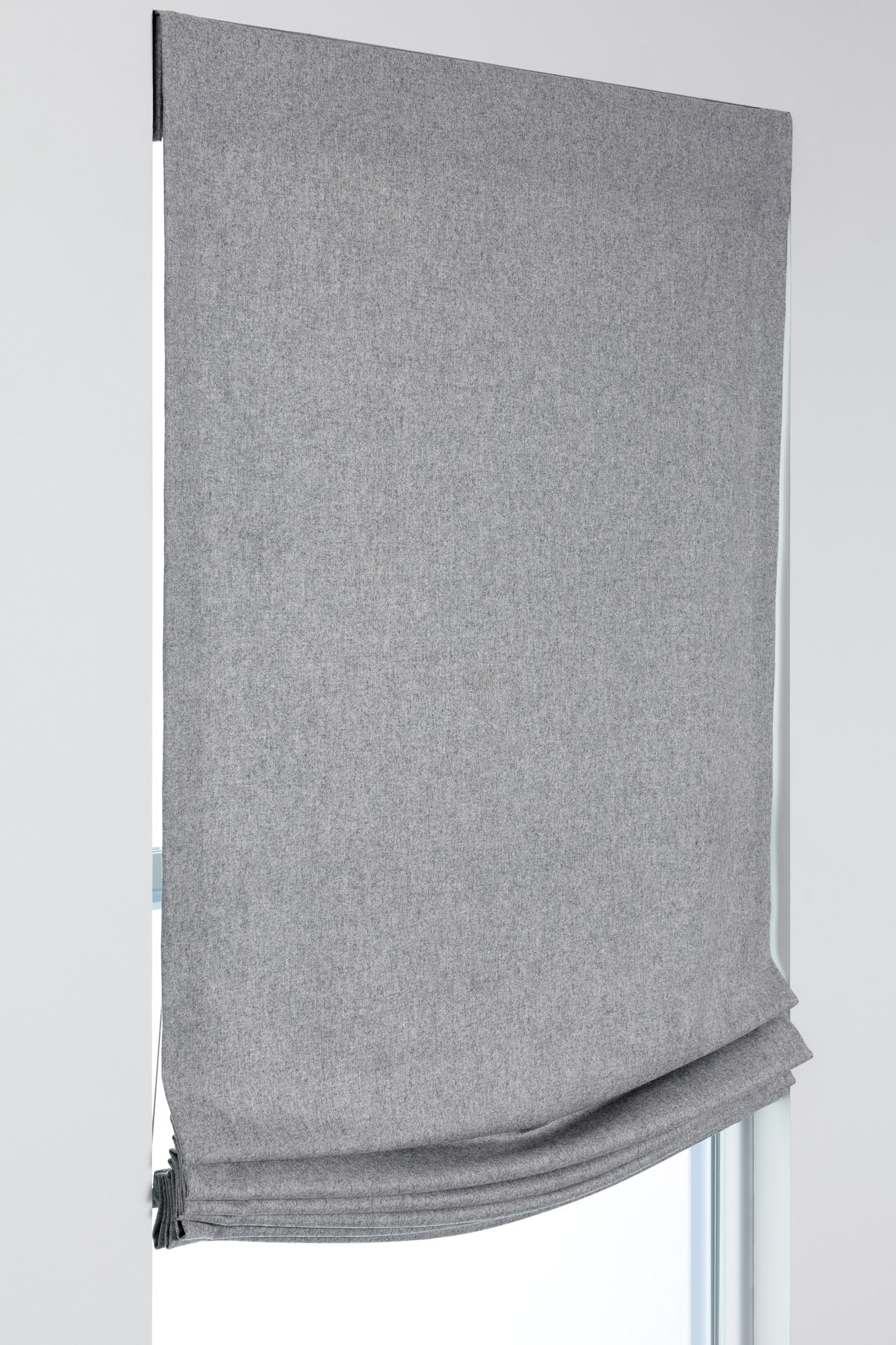 Relaxed Roman Shade example in gray fabric with a soft curved hem, shown flush mounted for a casual decorative look.