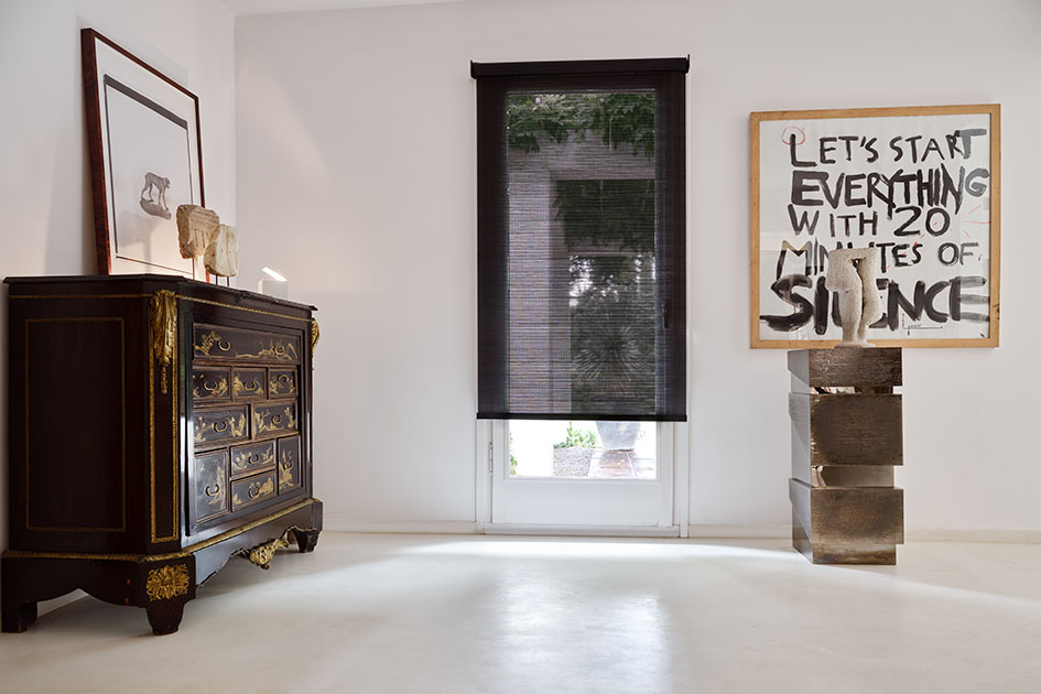 Hallway with tall window and semi-transparent solar shade, highlighting different types of window shades designed for light filtering and UV control