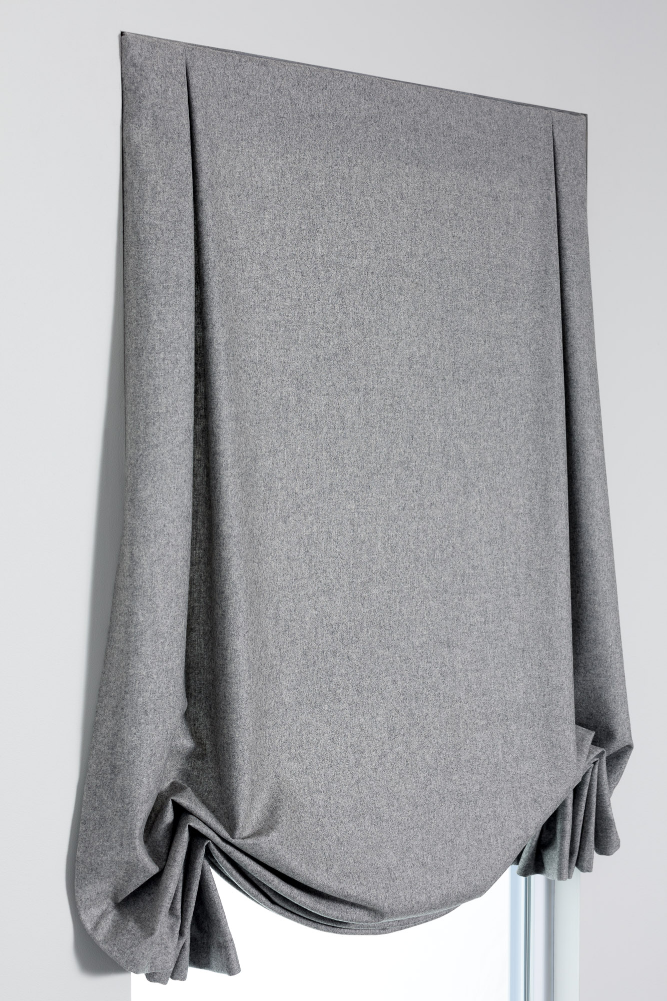 Tulip Roman Shade style in gray fabric raised part way, showing deep inverted pleats and a formal decorative shape.