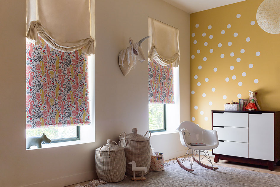 Nursery curtains layered over blackout Roller Shades block light for naps and nighttime sleep