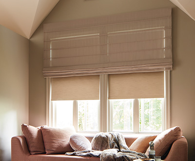 Roman shades for windows include Aventura Roman Shades made of Basket Sheer in Sand in a warm-toned sitting room