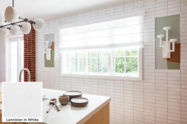 A bright modern kitchen has Roman Shades for kitchen windows made of Lannister Sheer in White which softens light