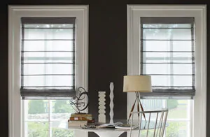 Roman shades for windows include Aventura Roman Shades made of Wool Blend in Urban Grey in a darkly painted room