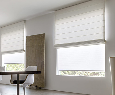 Roman shades for windows include Cascade Roman Shades made of Cotton in White in a chic minimalist white dining room