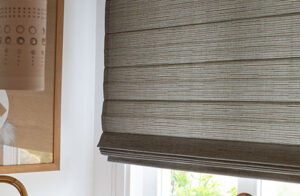 A close up of a Cascade Woven Wood Shades made of Jackson in Sun shows the warm grey color and natural texture