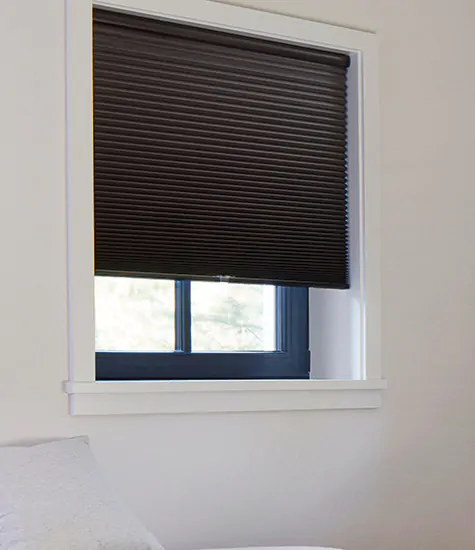 A white room has blackout shades for nursery windows made of Cellular Shades, 3/4 single cell blackout material in Midnight