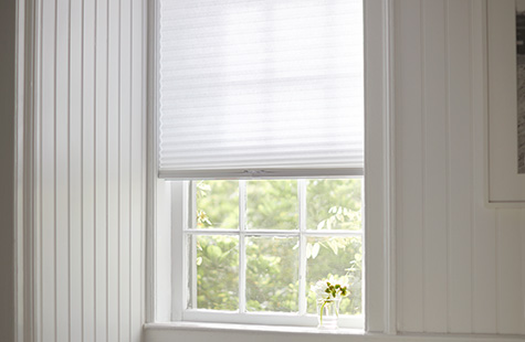 A small window has a light filtering Cellular Shade made of 3-4 Single Cell material in Lace for a soft, subtle look