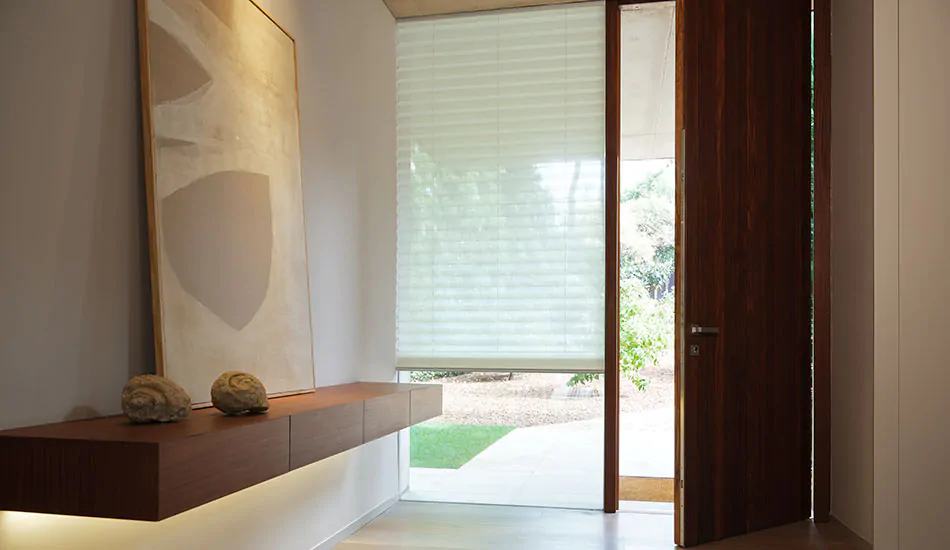 A modern entryway features a Cellular Shade on the window next to the door, made from Napoli material in Natural