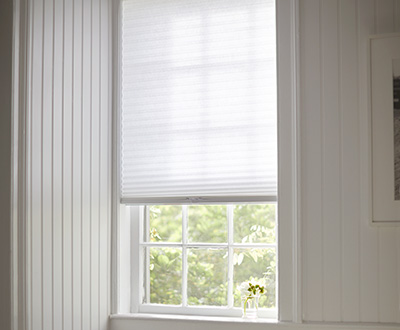 Window shades in a simple bathroom include Cellular Shade made of Single Cell Light Filtering material in Lace