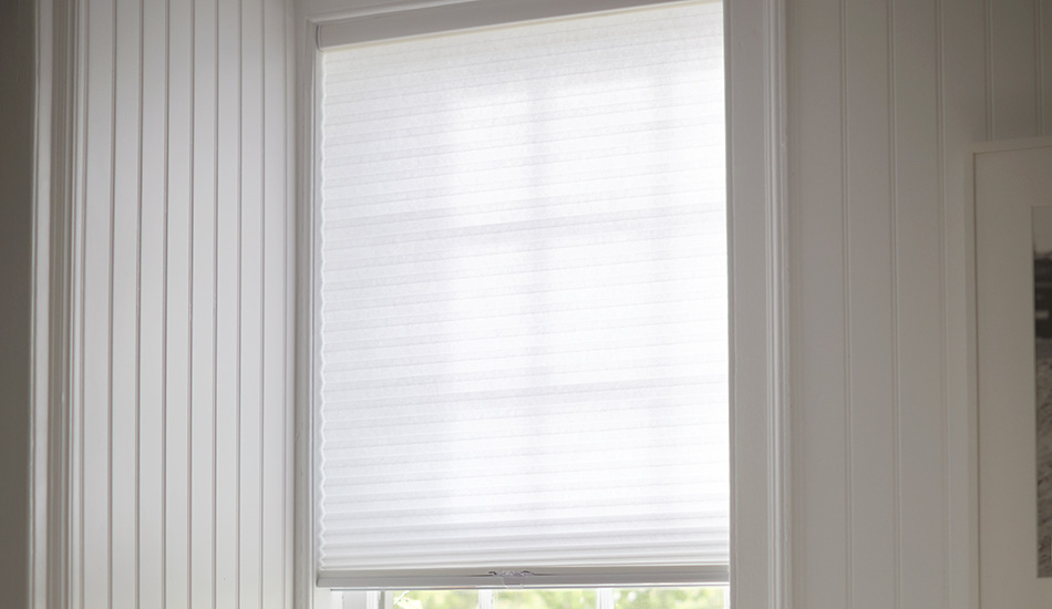 A Cellular Shade made of light filtering single cell material in Lace covers a small window in a bathroom for privacy