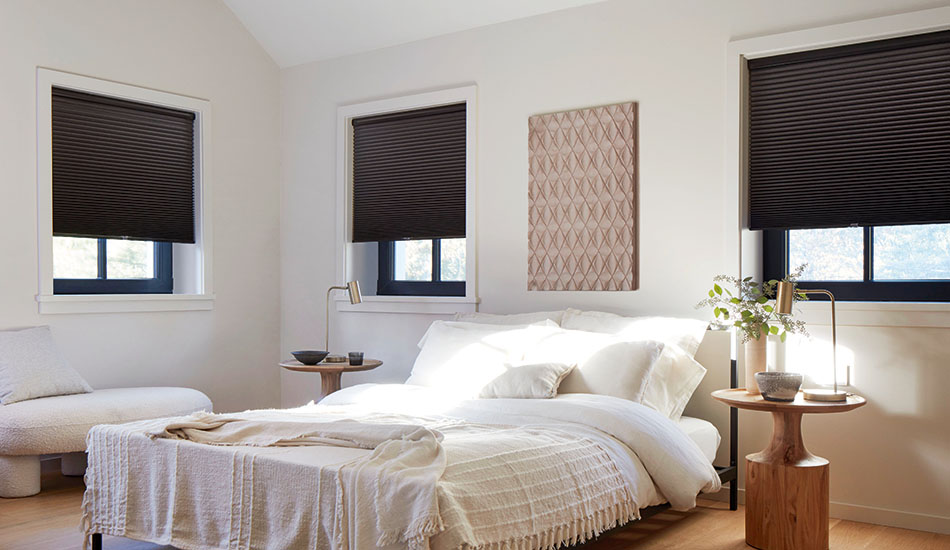 Pull down window shades in the Cellular Shade style made of single cell blackout in Midnight contrast the warm white walls