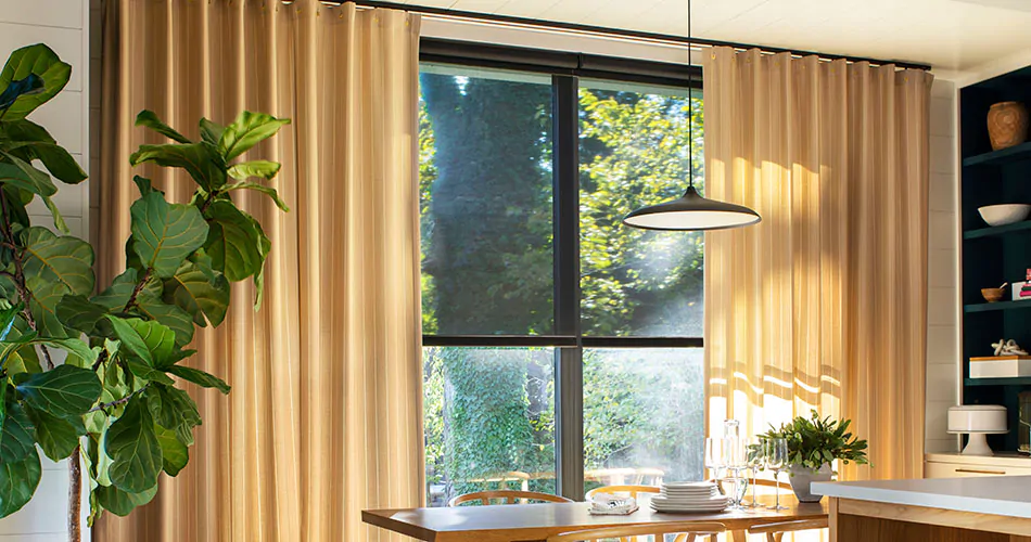 Cubicle drapery with a golden color shows one type of drapery pleat styles in a bright open kitchen