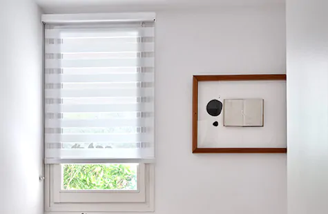 Double Roller Shades made of Catalina material in White deliver a linear look to a mid-century modern bedroom