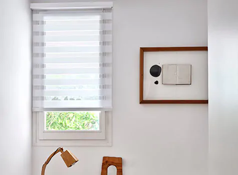 Double Roller Shades made of Catalina material in White deliver a linear look to a mid-century modern bedroom