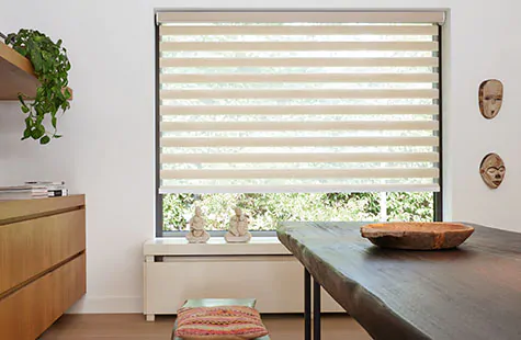 Double Roller Shade made of Windansea in Canyon offers a linear design to a window in a mid-century modern dining room