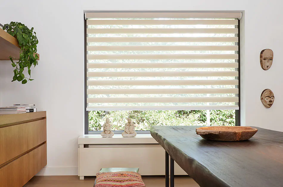 Double roller shades made of Windansea in Canyon cover a wide picture frame window in a mid-century modern kitchen