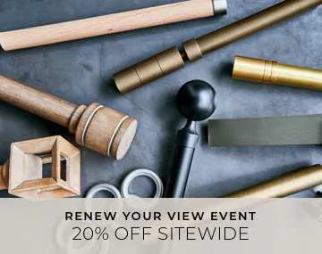 Pieces of drapery hardware in metal & wood finishes lay on a cement table with overlaid sales messaging for 20% off sitewide