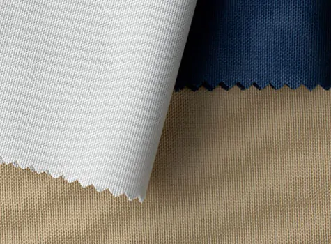 Swatches of Canvas in Optic White, Beige & Nautical lay folded on a table and are a good choice for curtains to keep heat out