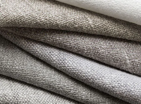 Swatches of Heathered Linen in multiple colors are stacked invitingly and are a great choice for curtains to keep heat out