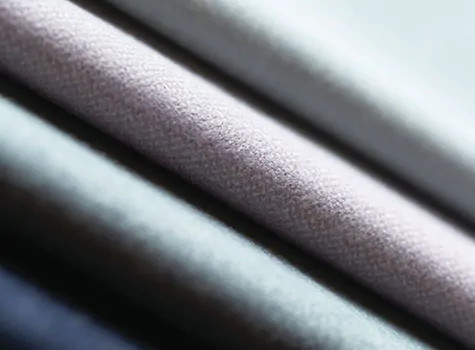 Swatches of Holland & Sherry Wool Flannel in pastel colors are stacked and are a great choice for curtains to keep heat out