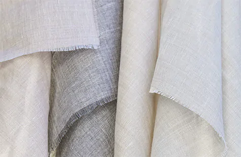 A close up of swatches made of Sheer Wool Blend shows the delicate soft look of this material for curtain sheers