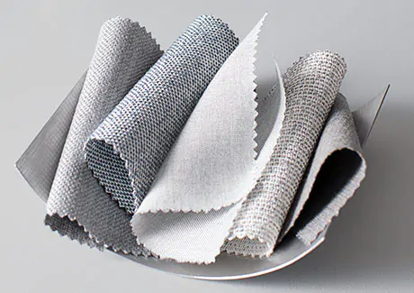 Swatches of Sunbrella material are piled decoratively ina bowl, showing their neutral colors and crisp look and feel