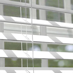 A close up of Faux Wood Blinds made of 2-inch Faux in Blanc shows how the slats offer great bathroom window privacy