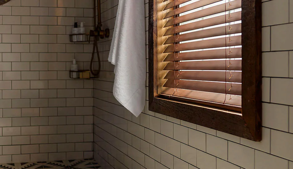 Faux Wood Blinds made of 2-inch Faux in Nutmeg deliver bathroom window privacy in a stand-up shower with tiles