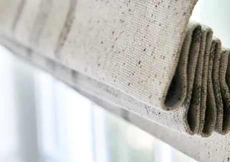 A close up of a Flat Roman Shade made of Aberdeen in Oat shows an ideal pattern and texture for farmhouse window treatments