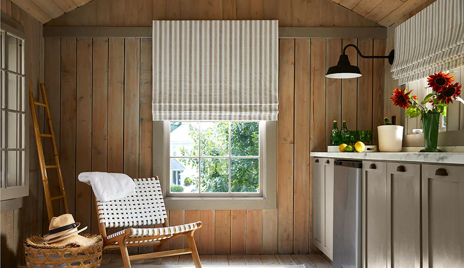 Roman shades for windows include a Flat Roman Shade made of Awning Stripe in Fawn in a wood-framed pool house