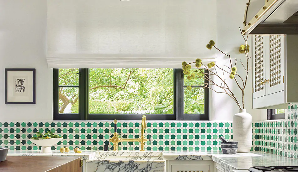 Roman Shades for kitchen windows made of Tangier Weave in Blanco add texture to a kitchen with Mediterranean tiles