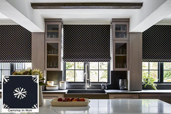 A kitchen with dark colors has Roman Shades for kitchen windows made of Nate Berkus Gemma in Noir for a bold look
