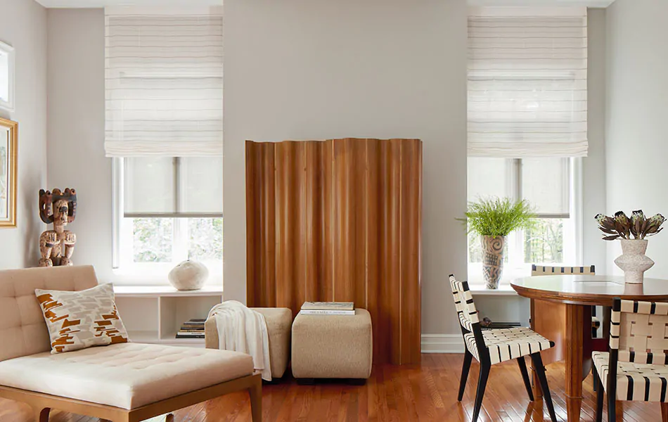 Flat Roman Shades made of Sahara Stripe in Desert are used as alternatives to Scandinavian curtains in a lounge filled with wood tones