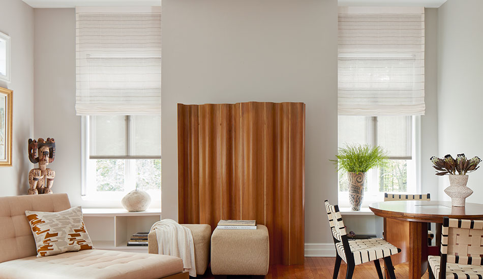 Window Shades in a living room with wood tones include Flat Roman Shades made of Sahara Stripe in Desert