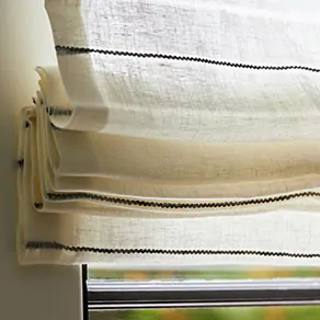 A close up of a Flat Roman Shades made of Sahara Stripe in Onyx shows the simple folds of the shade style