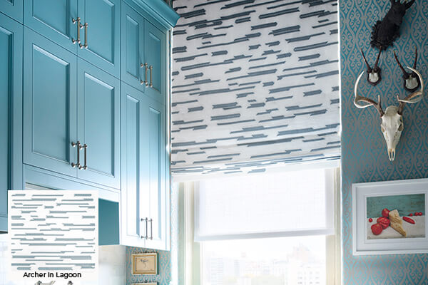 Geometric patterns, one of the window treatment trends 2024, is seen in this kitchen's asymmetrically Flat Roman Shade design