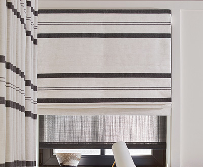 Roman shades for windows include a Flat Roman Shade made of Shoreham Stripe in Jet with privacy interlining for insulation