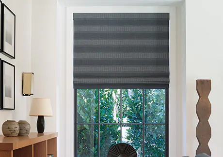 To compare light filtering vs blackout a Roman Shade made of Jasmine in Midnight features blackout lining