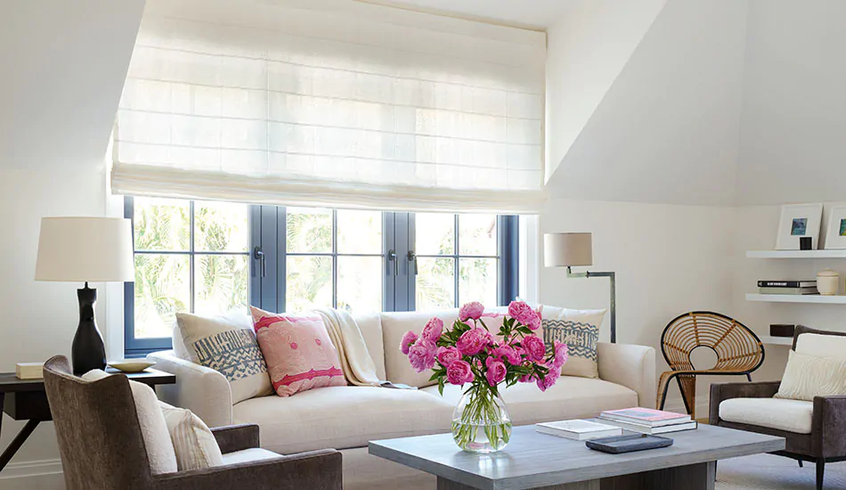 A sitting area shows tips for how to brighten a dark room with its bright Flat Roman Shades made of Sankaty Stripe in Moon