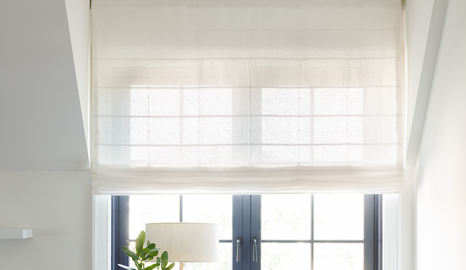 A Flat Roman Shade made of Sankaty Stripe in Moon matches the white walls and shows how to install shades in an inset window