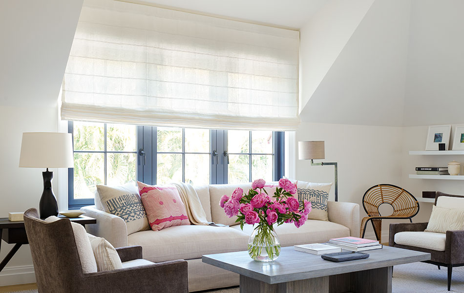 Flat linen Roman Shades made of Victoria Hagan's Sankaty Stripe in Moon gently filter light into a bright white sitting room