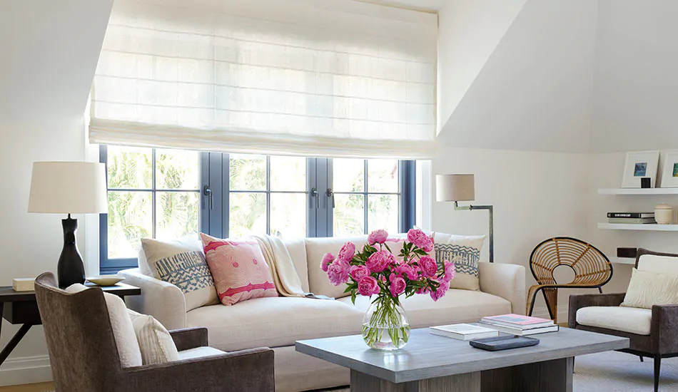 A bright sitting room shows a Flat Roman Shade made of Sankaty Stripe in Moon as an alternative to Cellular Shades