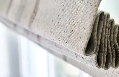 A close up image of a flat roman shade in Aberdeen Oat shows how stack affects shades for sliding glass doors