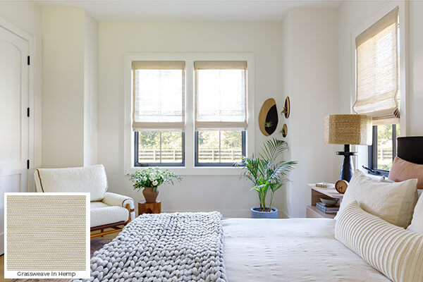 One of the window treatment trends 2024 is the use of warm neutrals seen on these woven wood shades in a guest bedroom