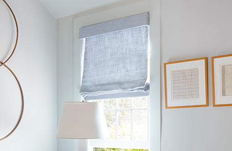 Roman shades for windows include a Flat Roman Shade made of Heathered Linen in Sky with an upholstered valance