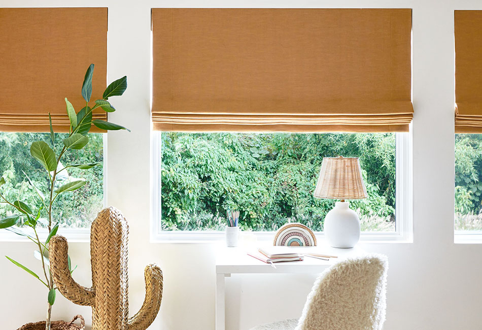 A child's room has flat linen Roman Shades made of Nate Berkus Lisbon Woven in Bronze for an inviting warm color